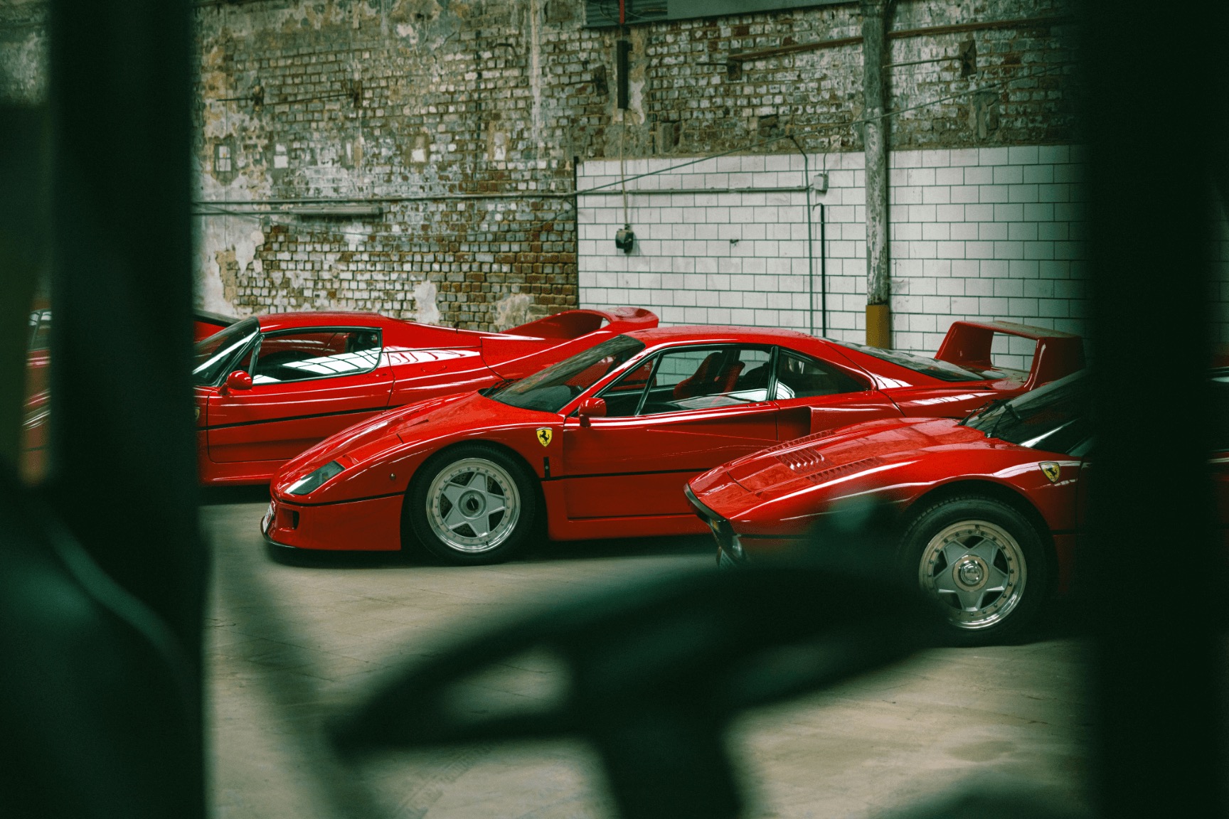 red sports cars in a parking garage
